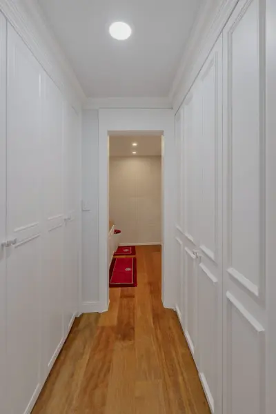 양면 수납장을 갖춘 화이트톤 드레스룸 복도